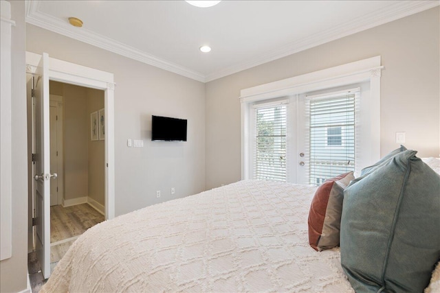 bedroom featuring french doors, ornamental molding, access to exterior, and light wood-type flooring