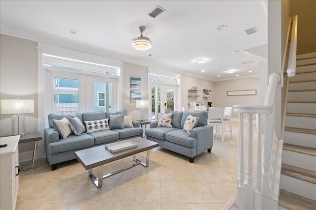 living room with french doors, crown molding, and light tile floors