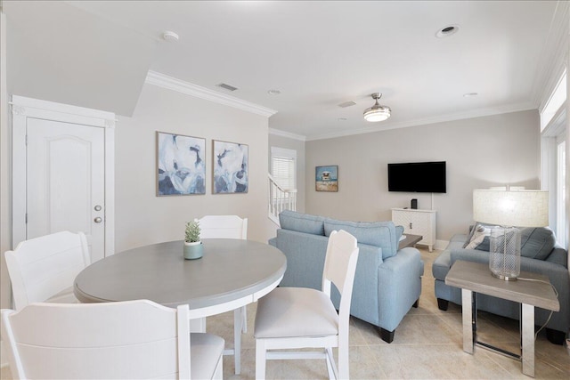 dining room with ornamental molding and ceiling fan