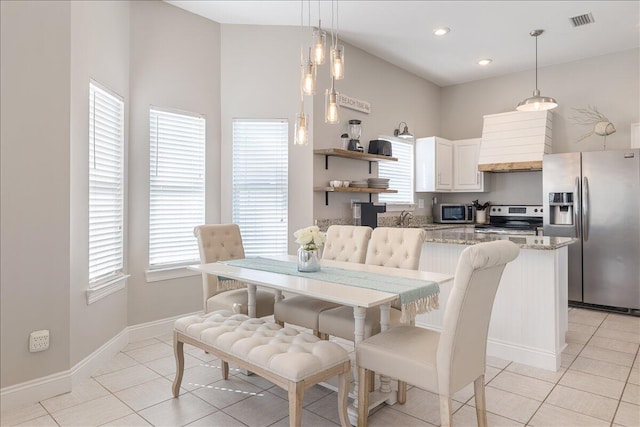 dining area with sink and light tile flooring