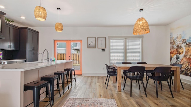 dining area with light hardwood / wood-style flooring and sink