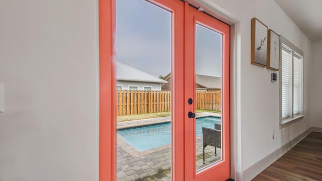 doorway to outside with french doors and dark wood-type flooring