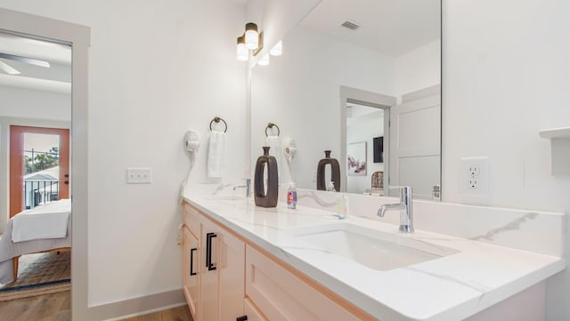 bathroom featuring double vanity, wood-type flooring, and ceiling fan