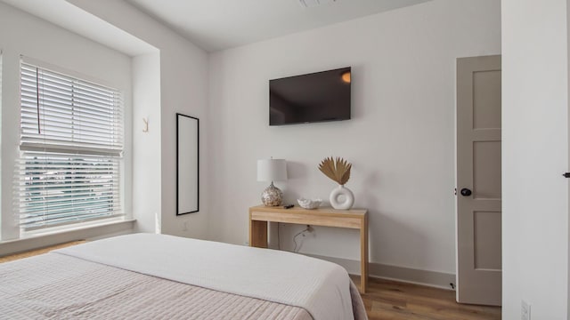 bedroom with dark wood-type flooring