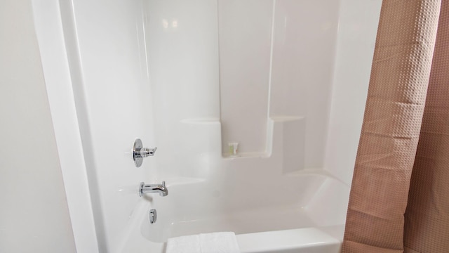 bathroom with shower / tub combo with curtain