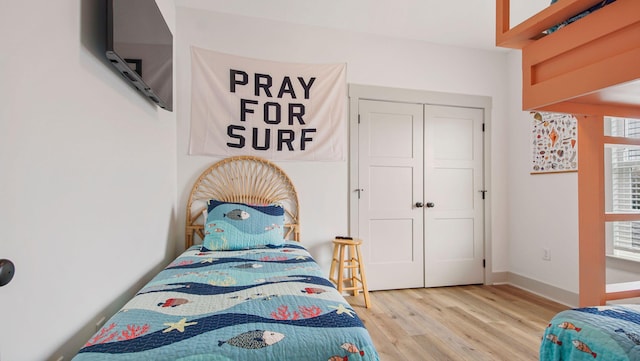 bedroom featuring light hardwood / wood-style flooring and a closet