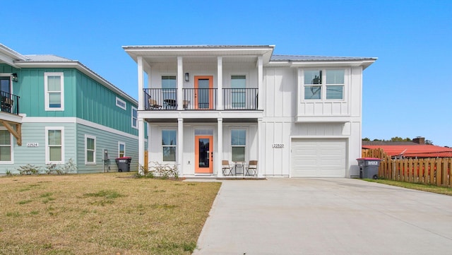 view of front of home with a garage, a balcony, and a front lawn