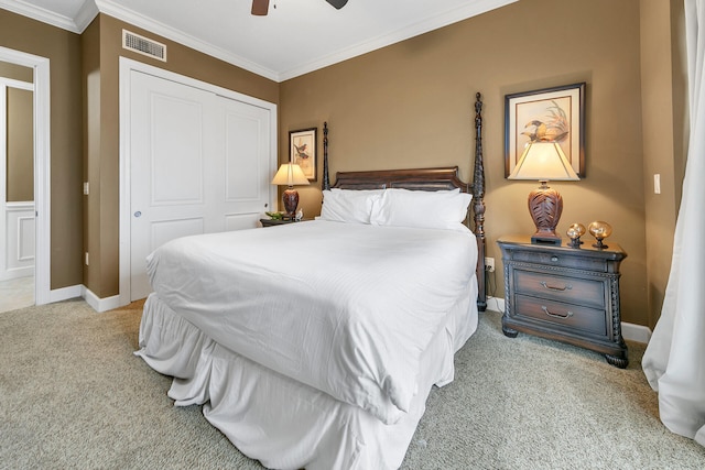 bedroom featuring crown molding, a closet, light colored carpet, visible vents, and baseboards