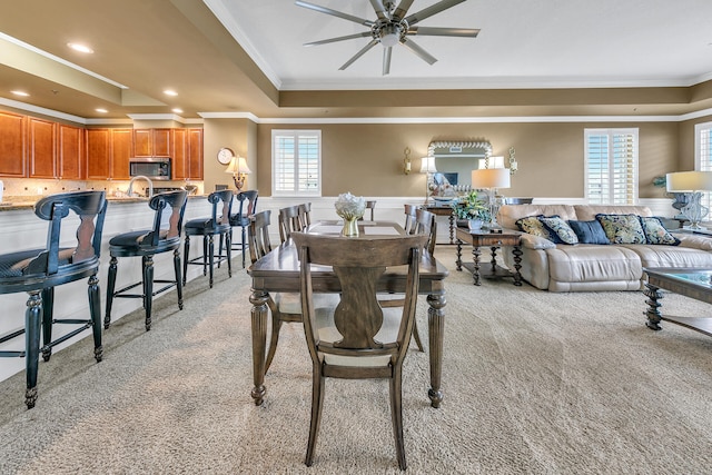 dining room featuring recessed lighting, a wainscoted wall, light colored carpet, a ceiling fan, and crown molding