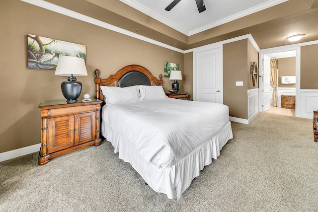 bedroom featuring ensuite bathroom, ornamental molding, carpet flooring, ceiling fan, and baseboards