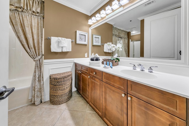 bathroom with crown molding, visible vents, wainscoting, a sink, and tile patterned flooring