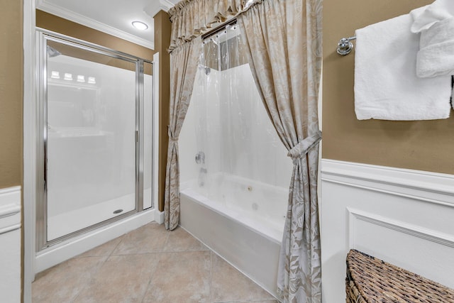 full bathroom with a tub to relax in, a shower with shower door, a wainscoted wall, ornamental molding, and tile patterned floors