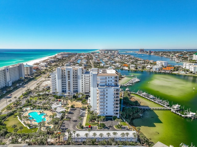 drone / aerial view with a water view and a beach view