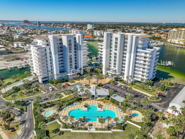 birds eye view of property featuring a water view and a city view