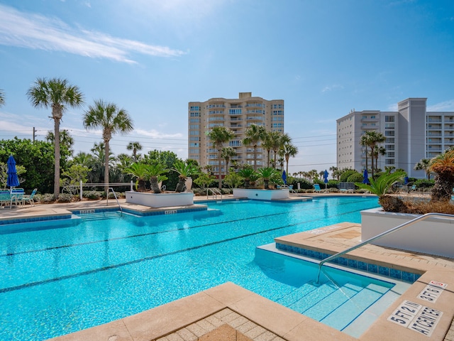 community pool featuring a view of city and a patio