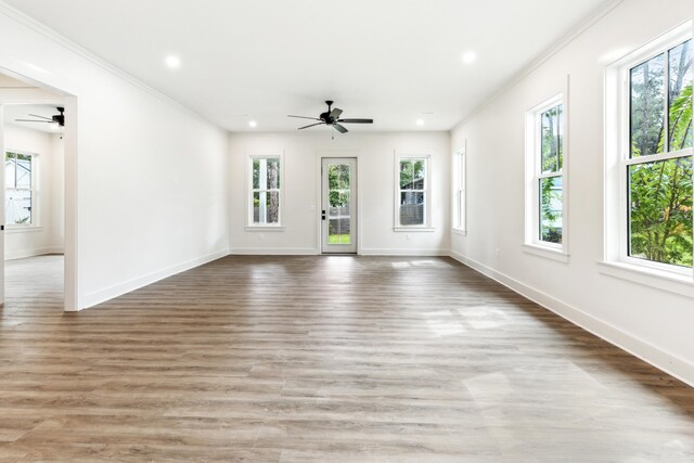 unfurnished living room featuring ornamental molding, hardwood / wood-style flooring, and ceiling fan