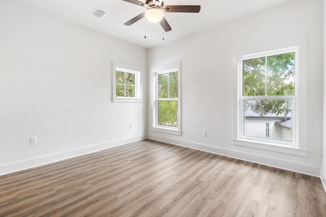 empty room with hardwood / wood-style flooring and ceiling fan