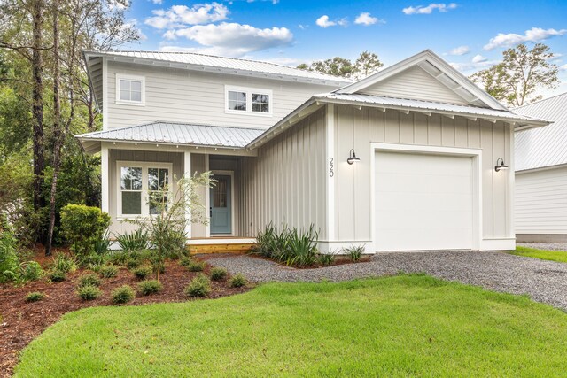 view of front facade featuring a garage, a porch, and a front yard