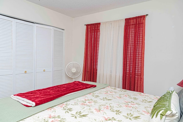 bedroom with a closet and a textured ceiling