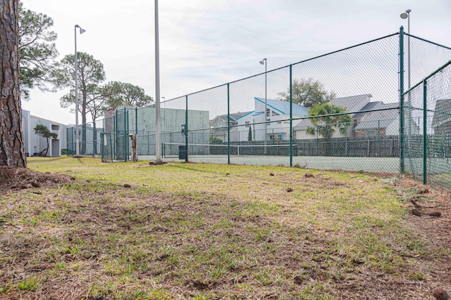 view of tennis court with basketball hoop