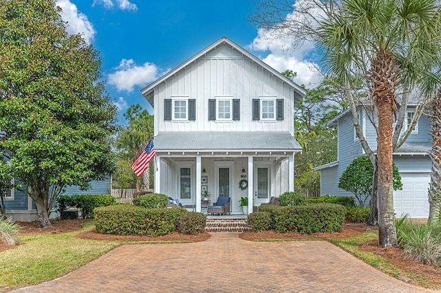 view of front of home featuring covered porch and a garage