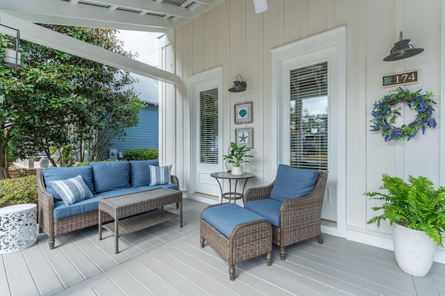 wooden terrace with an outdoor living space