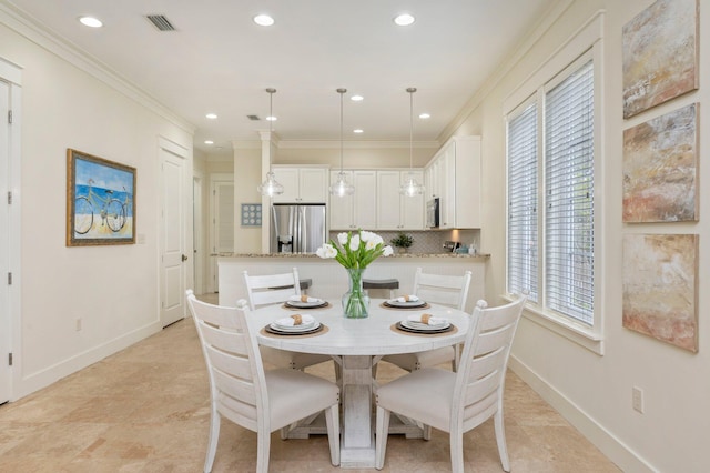 dining area with crown molding and light tile floors