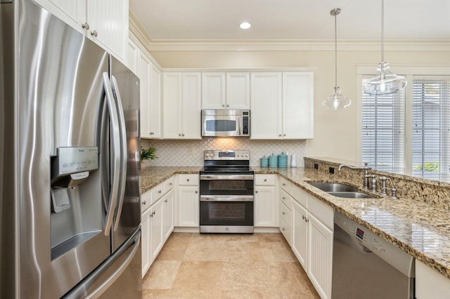 kitchen with hanging light fixtures, sink, stainless steel appliances, and light stone countertops