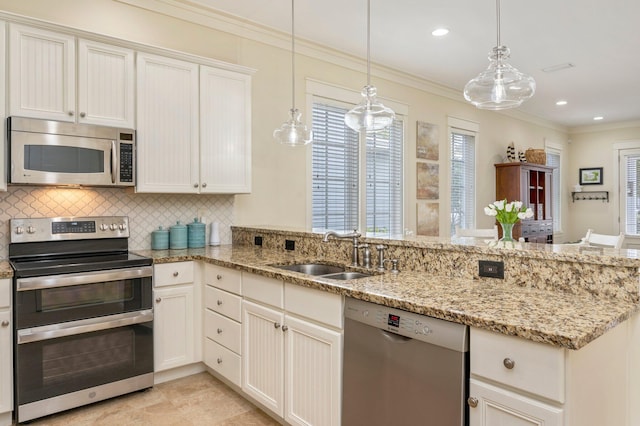 kitchen featuring appliances with stainless steel finishes, sink, tasteful backsplash, kitchen peninsula, and pendant lighting