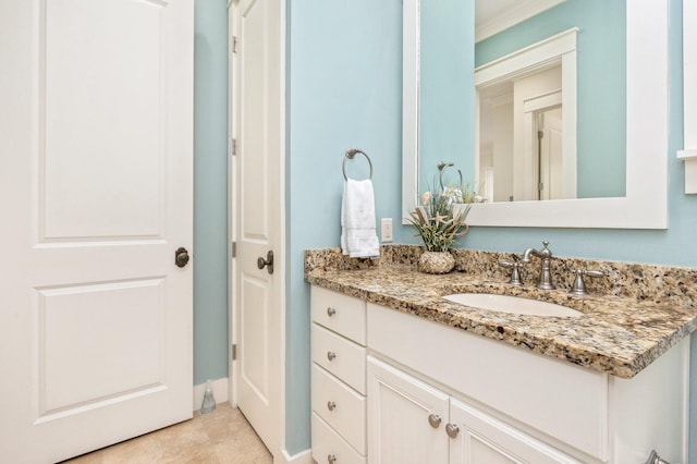 bathroom with tile floors, vanity with extensive cabinet space, and ornamental molding