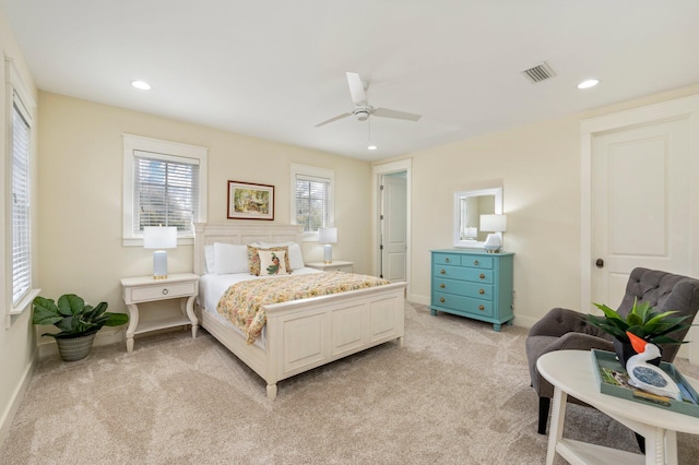 bedroom featuring light colored carpet and ceiling fan