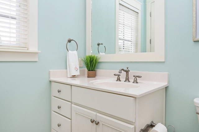 bathroom featuring oversized vanity and toilet