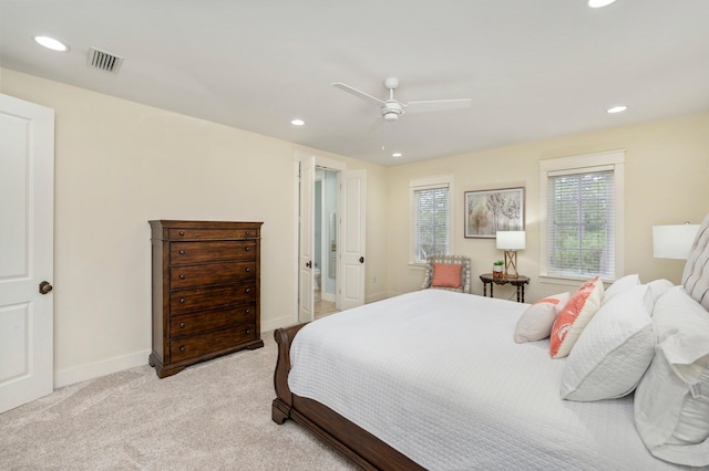 carpeted bedroom featuring multiple windows and ceiling fan