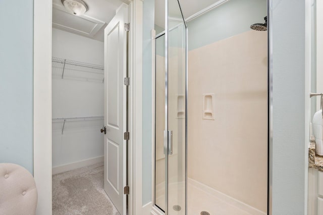 bathroom featuring a shower with shower door