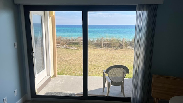 doorway to outside with a water view and a wealth of natural light