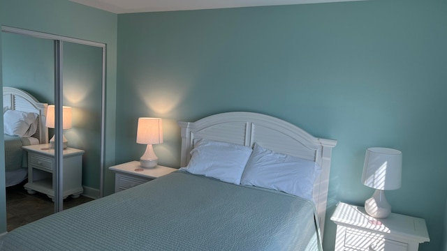 bedroom featuring a closet and dark tile floors