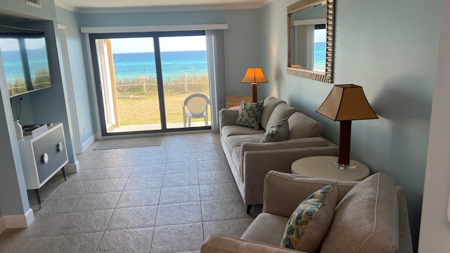 tiled living room featuring crown molding and a water view