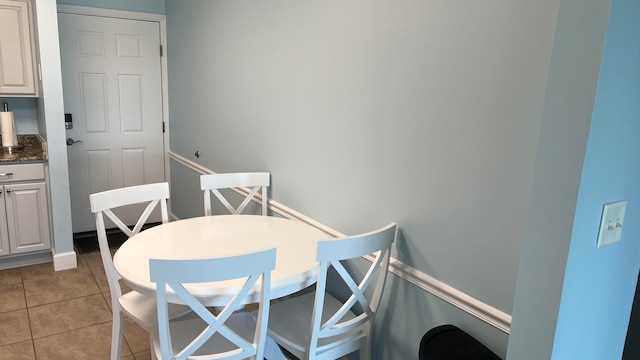 dining space with light tile floors