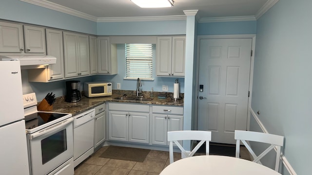 kitchen featuring white appliances, white cabinets, sink, light tile floors, and ornamental molding