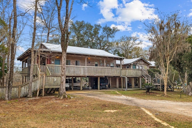 back of house featuring a deck and a yard