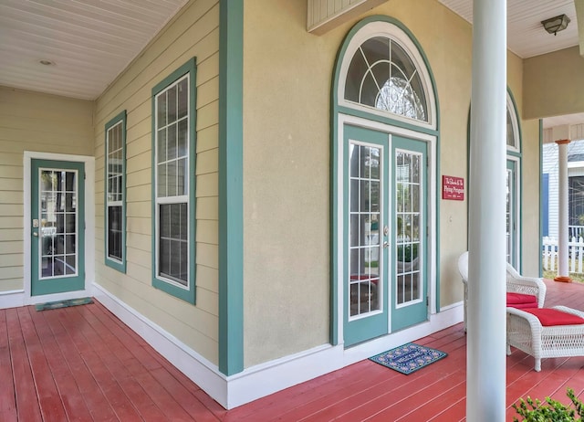 view of exterior entry with covered porch