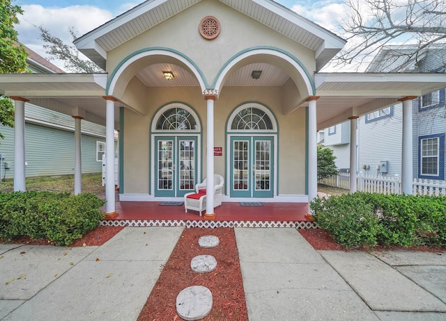 view of exterior entry with french doors and covered porch