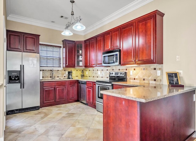 kitchen with decorative light fixtures, light stone counters, appliances with stainless steel finishes, and kitchen peninsula