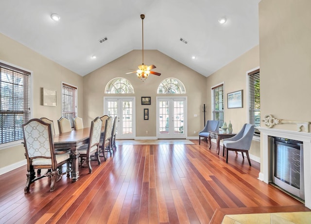 dining area featuring french doors, high vaulted ceiling, dark hardwood / wood-style flooring, and ceiling fan