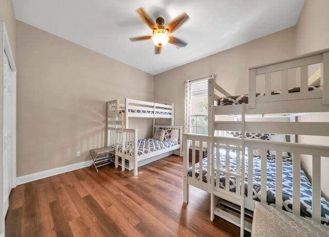 bedroom with dark hardwood / wood-style flooring and ceiling fan