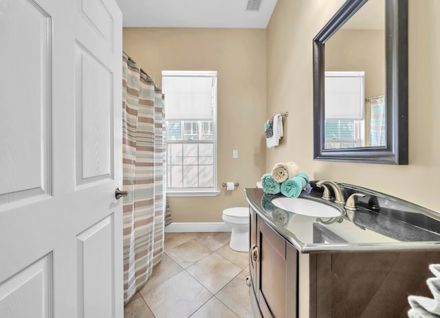 bathroom featuring plenty of natural light, toilet, tile floors, and vanity