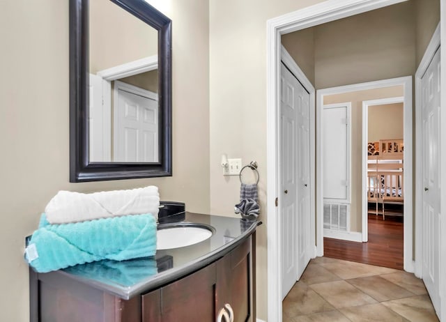 bathroom featuring vanity and tile floors