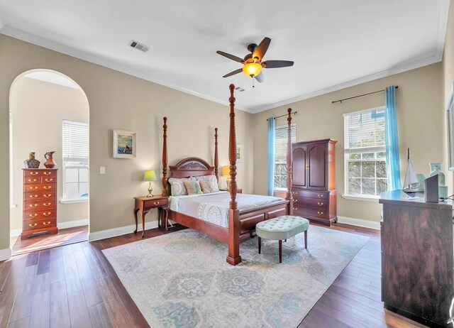 bedroom featuring crown molding, dark hardwood / wood-style flooring, and ceiling fan