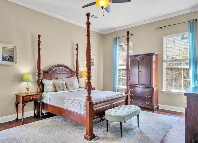 bedroom with crown molding, dark wood-type flooring, and ceiling fan