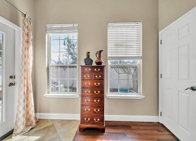 foyer entrance featuring dark tile floors